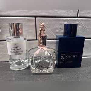 3 empty bottles of perfume and cologne bottles